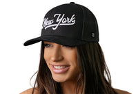 New York City White Script Trucker Hat  |  Black New York Snapback