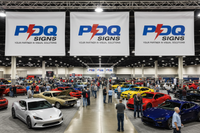 Vinyl banners hanging horizontal with grommets at car show background image with PDQ Signs logo 