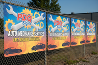 Vinyl Banners with grommets hanging off fench pdq signs logo for auto mechanics 